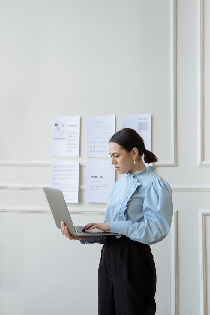 about-01 Focused businesswoman in a stylish office setting working on her laptop.
